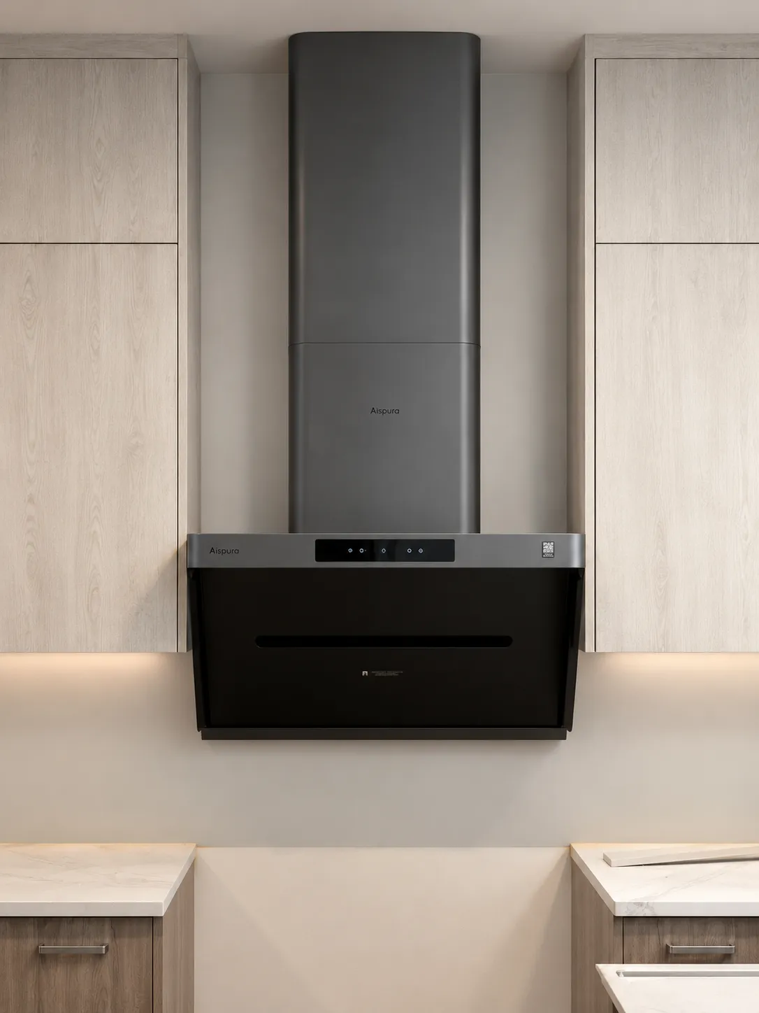 Modern kitchen with a sleek black range hood mounted between light wood cabinets.